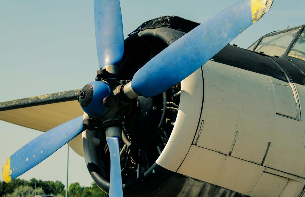 Detailed view of a vintage airplane propeller with blue blades, captured outdoors in Budapest.
