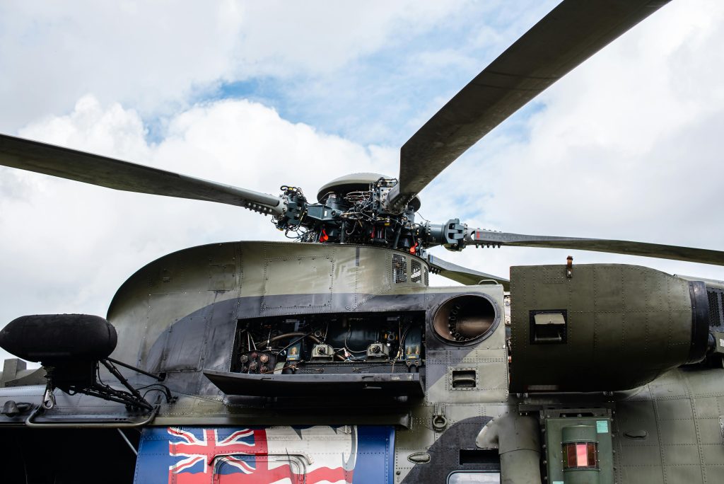 Detailed view of a military helicopter rotor and open mechanism, showing complex engineering.
